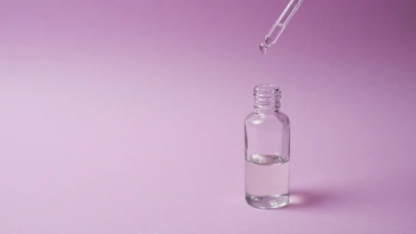 Cosmetic serum in a bottle with a pipette. - Footage, Video