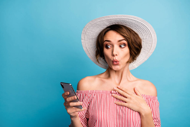 Close-up portrait of her she nice attractive girlish cheerful amazed brown-haired girl using device online shopping service pout lips isolated on bright vivid shine vibrant blue color background - Foto, Imagem