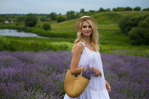 horizontal photo of a pretty blonde on a background of lavender  - Zdjęcie, obraz