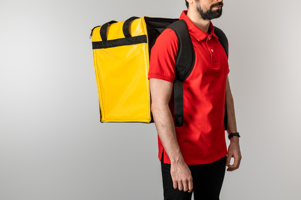 Cropped view of bearded courier with thermo backpack isolated on grey - Photo, Image