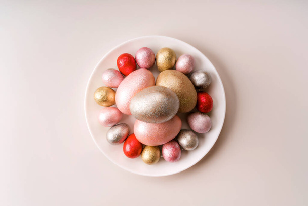 Colored chicken and quail eggs of pink, silver, golden, red, purple color  - Foto, imagen