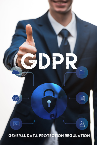 selective focus of happy businessman in suit showing thumb up near gdpr lettering on white  - Photo, Image