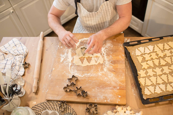 Young man bakes cookies - Valokuva, kuva
