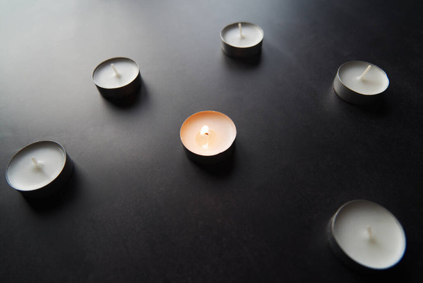 candles on black background- one lit - Fotoğraf, Görsel