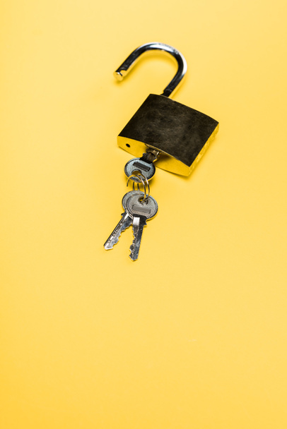 metallic padlock with keys isolated on yellow - Fotoğraf, Görsel