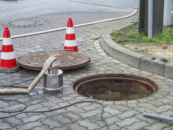 Open sewer with pump and manhole cover - Photo, Image