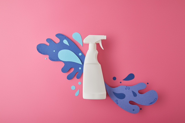 composition with spray bottle and blue water splashes made of paper, on pink - Photo, Image
