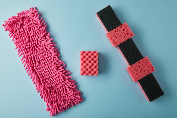 top view of pink rag and sponges for house cleaning on blue - Fotografie, Obrázek