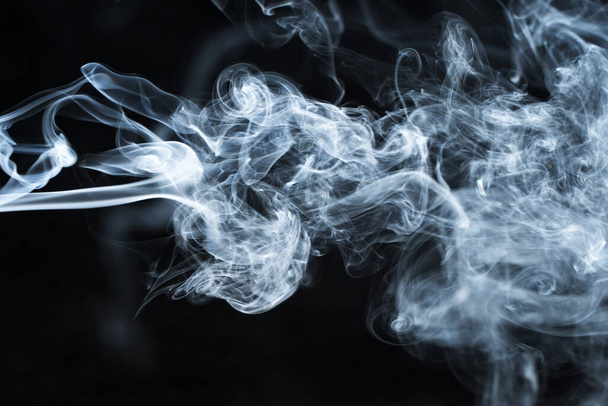 Photo of a wisp of smoke on a dark background - Foto, immagini