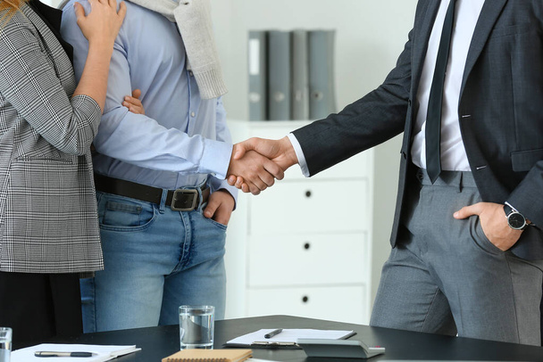 Bank manager and clients shaking hands in office - Photo, Image