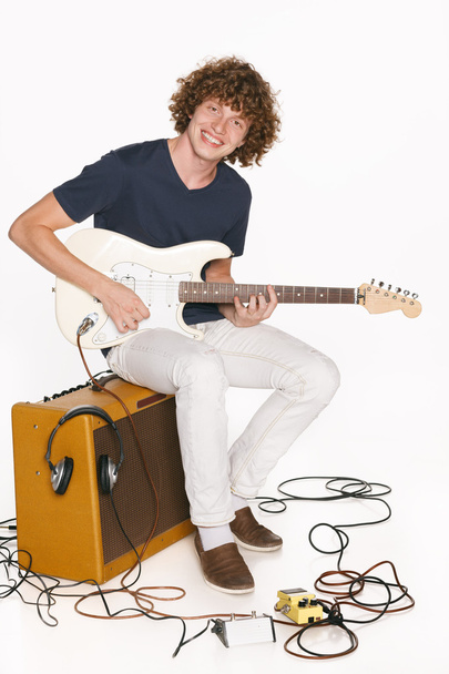Redheaded male musician with his electric guitar - 写真・画像