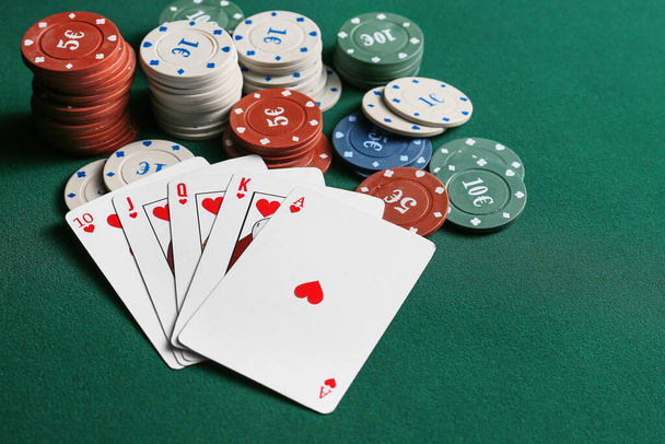 Chips and playing cards for gambling games on table in casino - Photo, Image