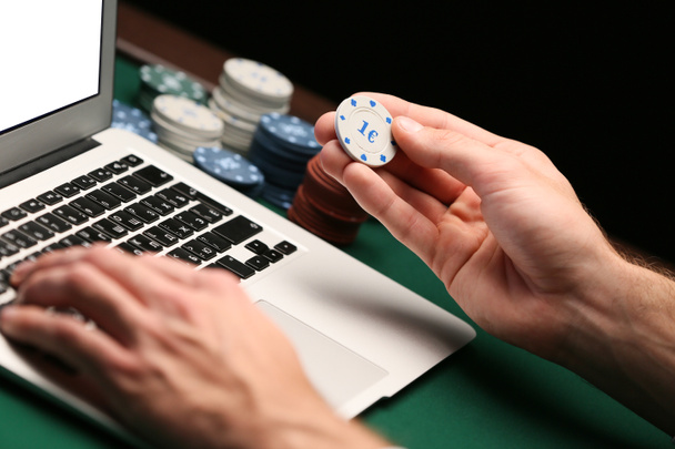 Man with laptop playing poker online, closeup - Photo, Image