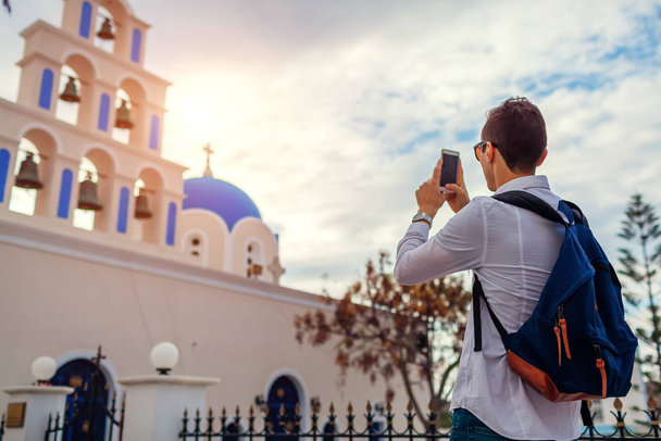 Santorini traveler taking photo of church in Akrotiri on smartphone. Tourism, traveling, vacation concept - Photo, Image