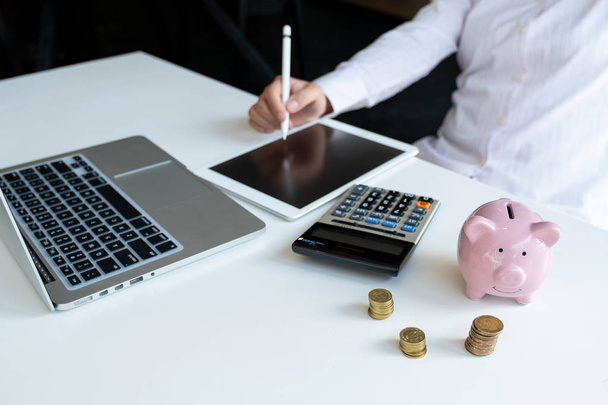 Pink piggy bank with business woman in office, saving for new business target and retirement concept - Photo, Image