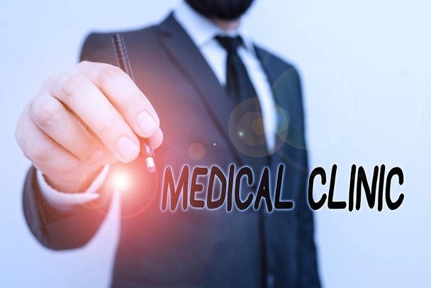 Conceptual hand writing showing Medical Clinic. Concept meaning facility that is primarily focused on the care of outpatients Male human with beard wear formal working suit clothes hand - Photo, Image