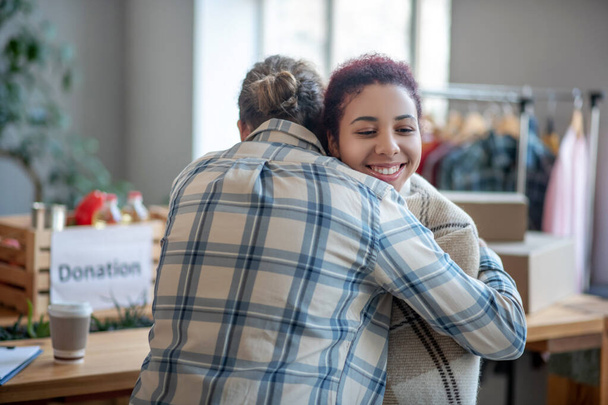 Man in plaid shirt hugging young smiling girl. - Foto, Imagen