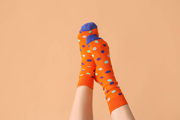 Legs of young woman in socks on color background - Valokuva, kuva