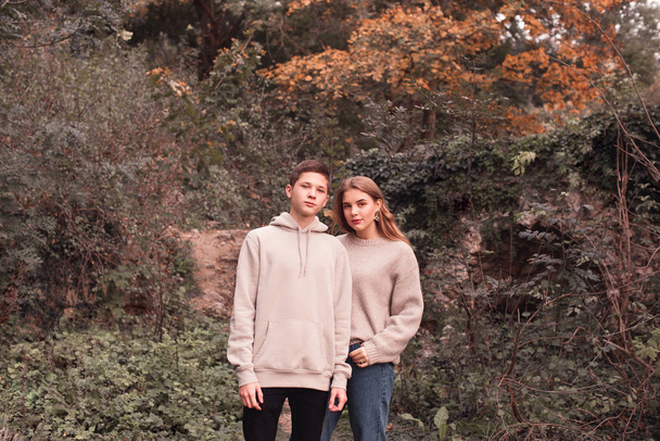 Stylish teenage couple standing outdoors. Looking at camera.  - Фото, зображення