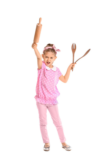 Little housewife with kitchen utensils on white background - Foto, afbeelding