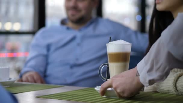 Closeup waiters hands putting latte on cafe table - Footage, Video