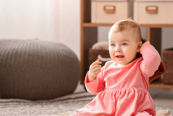 Cute baby girl in stylish dress at home - Photo, Image