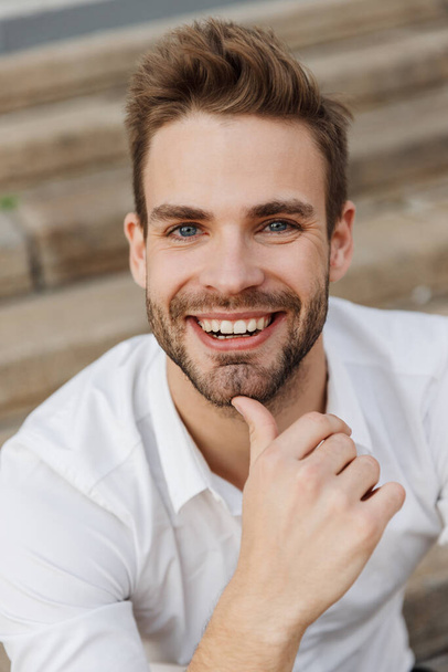 Close up of a handsome smiling young businessman - Фото, зображення