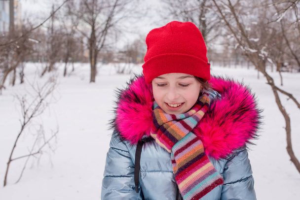Young beautiful woman winter portrait. Red hat. Hipster lifestyle. Portrait of a girl in a red hat in winter - Photo, Image