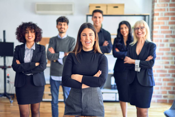 Group of business workers smiling happy and confident. Posing together with smile on face looking at the camera, young beautiful woman with crossed arms at the office - Photo, Image
