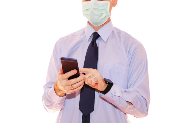 Close-up - businessman in a blue shirt and protective medical ma - Fotó, kép