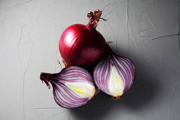 whole and onion red onion on concrete background - Φωτογραφία, εικόνα