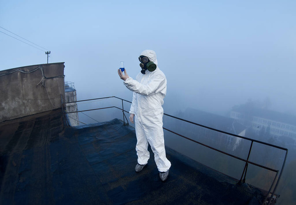 Фішея знімок вченого в захисному костюмі і газовій масці, який працює в потенційно небезпечній зоні відчуження, вивчаючи вміст колби
 - Фото, зображення