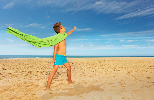 Boy pretend to be superhero with towel on sea - Zdjęcie, obraz
