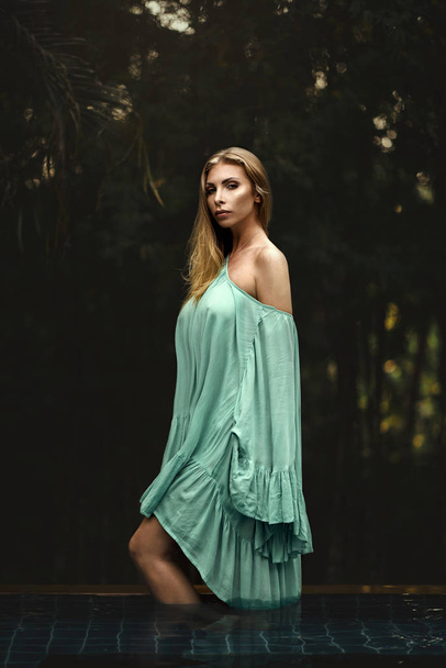 Fashion photo of beautiful young woman wearing green dress - Zdjęcie, obraz