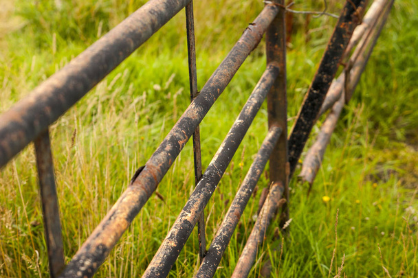 old metallic fence in a field - Fotoğraf, Görsel