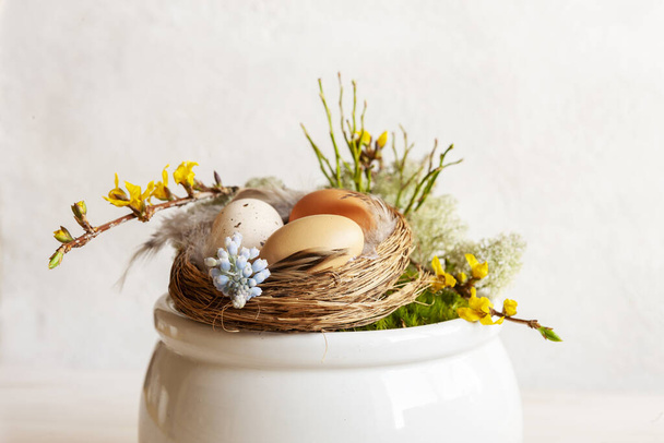 Easter decoration Easter eggs in the nest, spring flowers  - Photo, Image