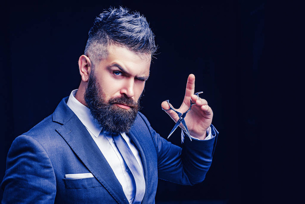 beard care. Mature hipster with beard. bearded man in formal business suit. brutal male hipster cut hair with hairdressing scissors. confident businessman at barbershop. barber and hairdresser salon - Фото, зображення