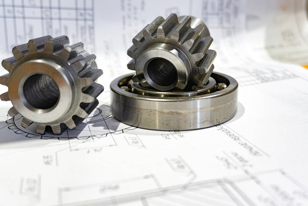 Gear and bearing lie on the technical drawing, concept of gear c - Photo, Image