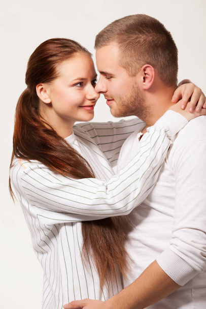 Young woman biting boyfriend ear. - Foto, Imagen