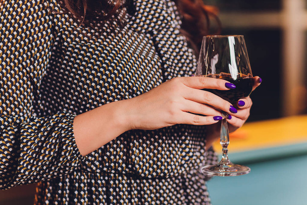 beautiful woman in a black dress with a glass in hand. - Foto, imagen