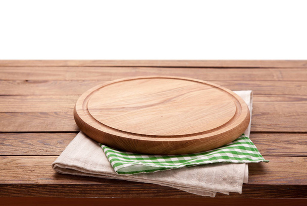 Board for pizza and tablecloth on wooden table isolated. Canvas, dish towels on white background top view mock up. Selective focus. - Zdjęcie, obraz