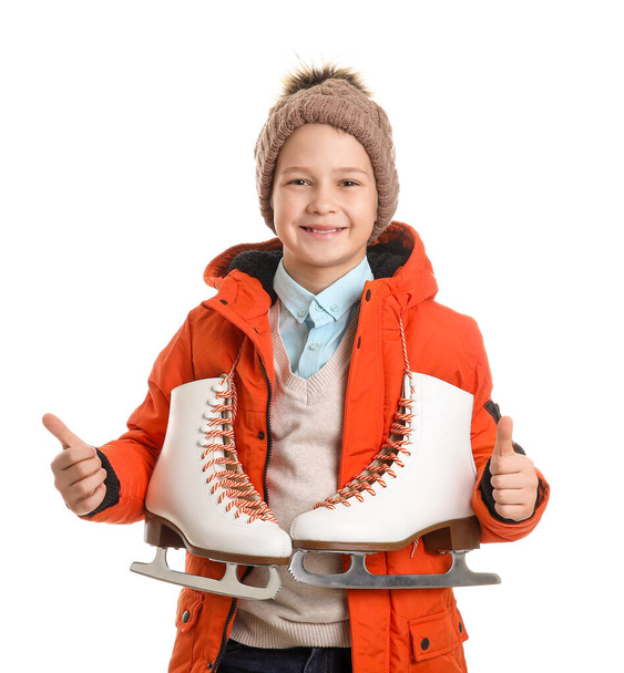Cute little boy with ice skates showing thumb-up against white background - Foto, Imagem