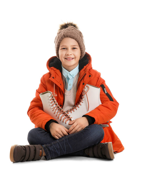 Cute little boy with ice skates against white background - Foto, imagen