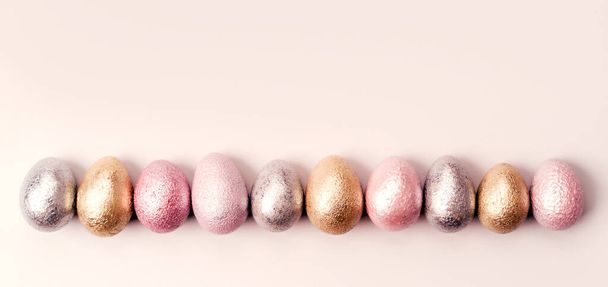 Colored chicken and quail eggs of pink, silver, golden, purple color  - Photo, Image