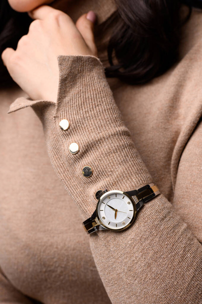  Stylish watch on woman hand. golden analog wrist watch - Fotoğraf, Görsel