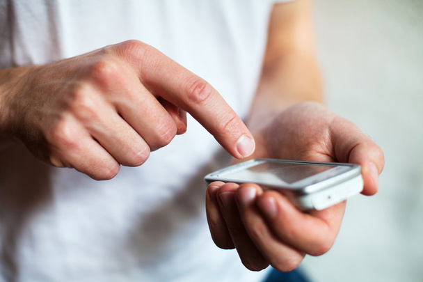 Man hands touching smartphone - Фото, изображение