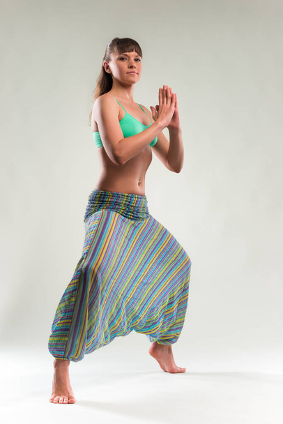 Beautiful young woman doing yoga exercise. - Photo, image