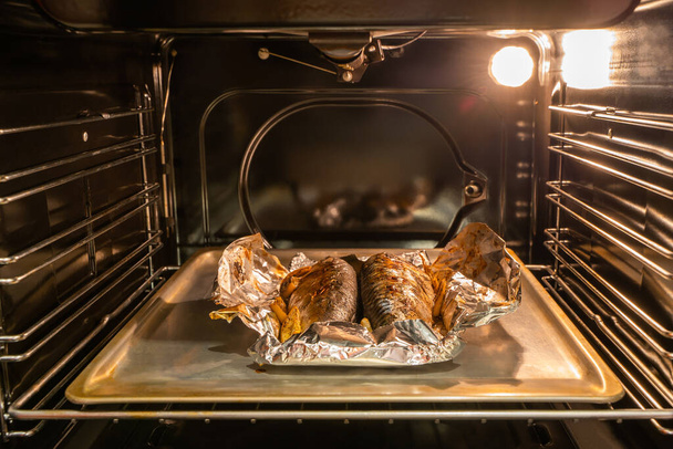Baked mackerel fish on the pan inside gas oven - Photo, image