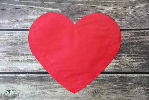 Red heart made of paper symbol of love on a background of wooden boards - Foto, imagen
