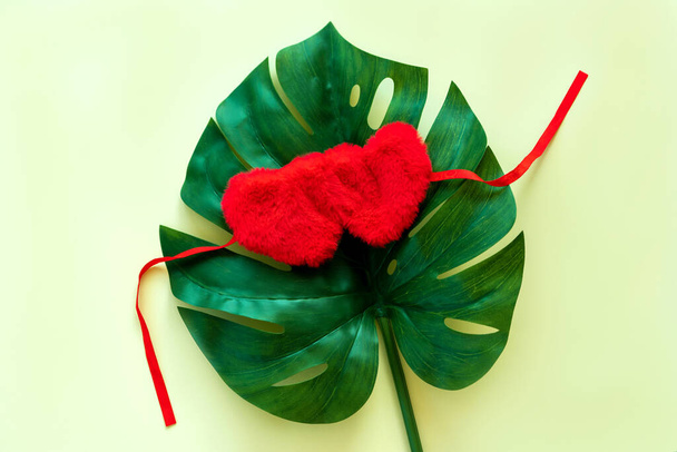 Big Leaf monstera heart shaped sleeping bandage for eyes. Valentines day - Foto, imagen